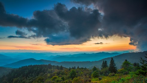 The light over the Appalachian Mountains along the Blue Ridge Parkway in Western North Carolina paints the sky with the setting sun.